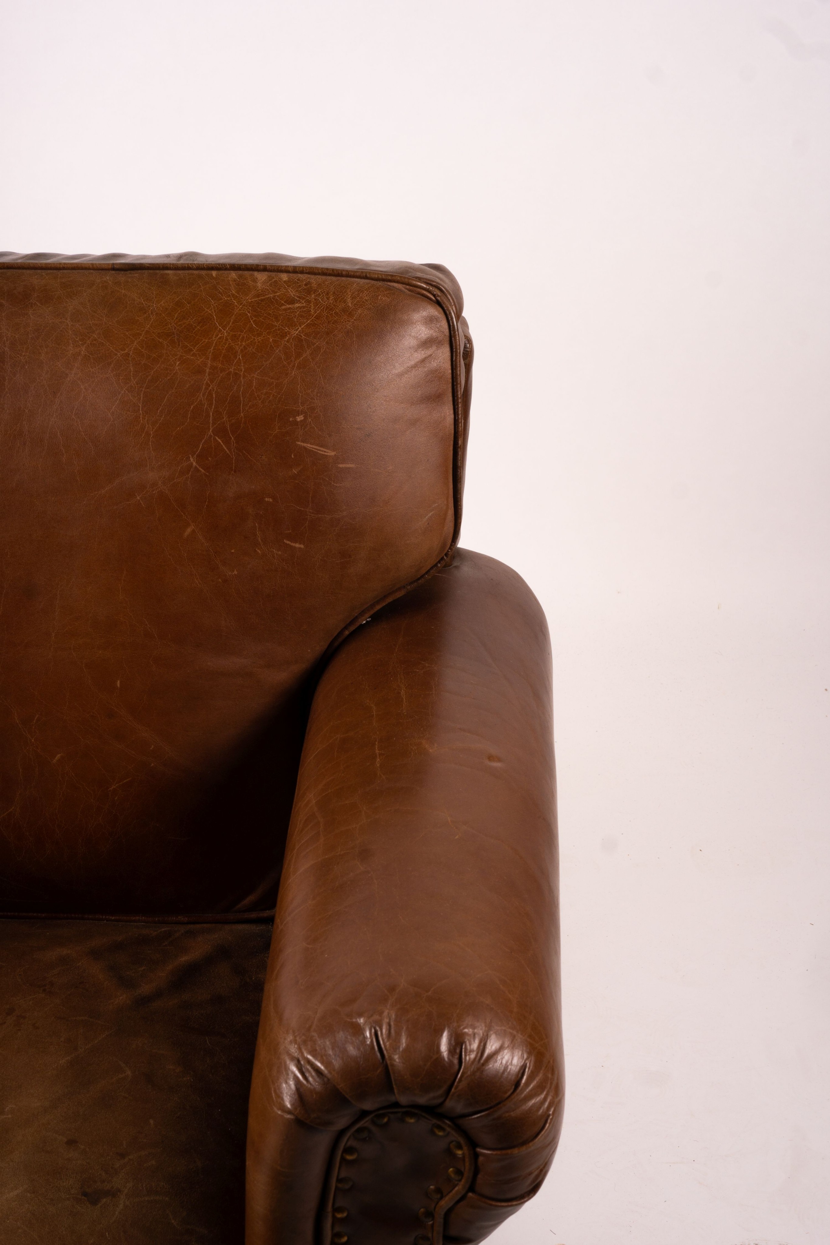 A pair of brown leather club armchairs, width 96cm, depth 80cm, height 90cm